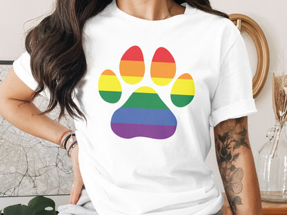 White t-shirt with a rainbow paw print design.