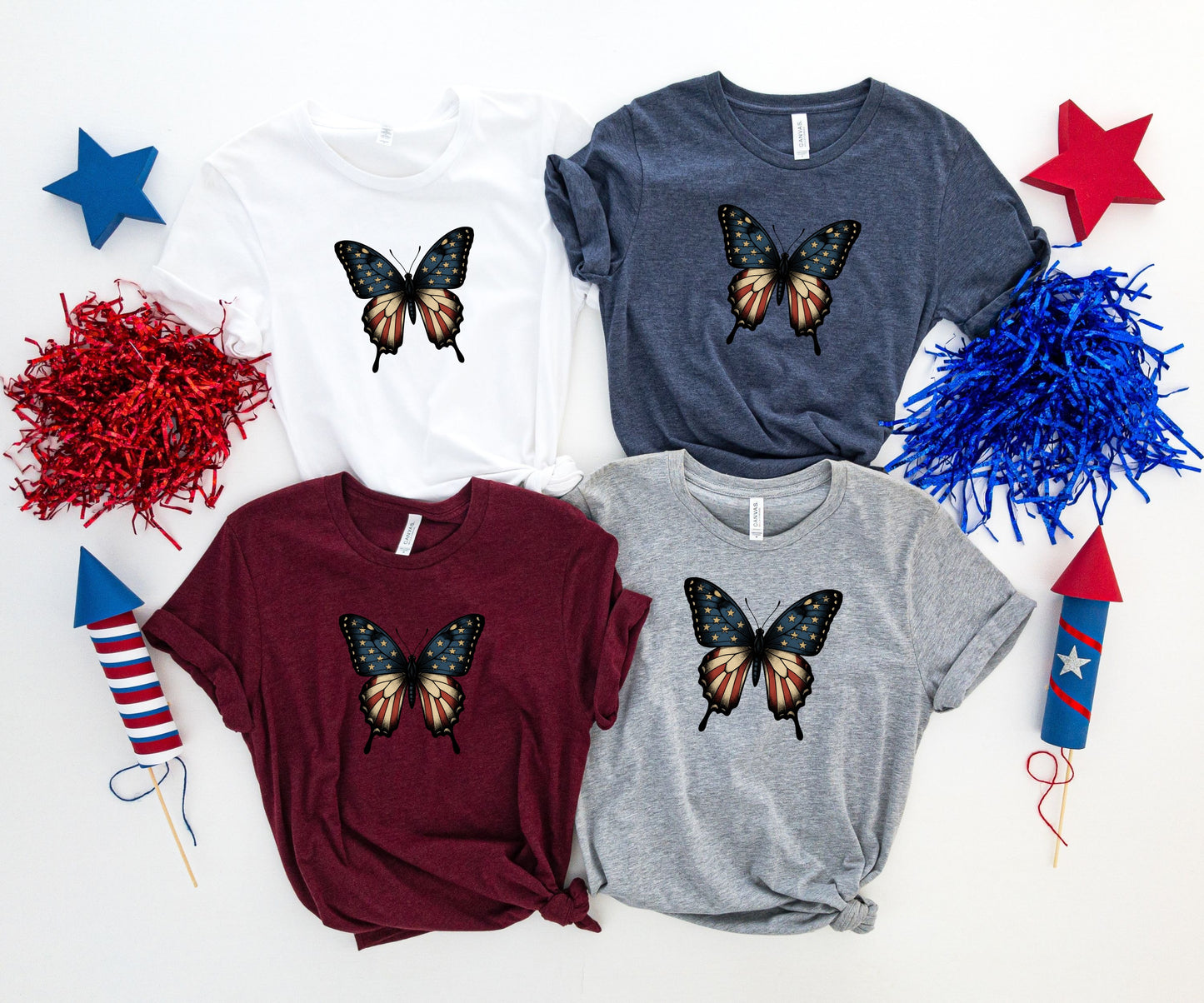 Four t-shirts with patriotic butterfly graphic in white, burgundy, navy, and grey.