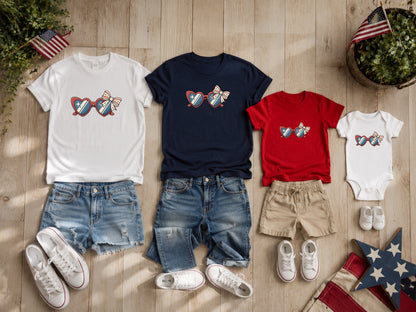 Three t-shirts and a onesie with patriotic heart sunglasses design, denim shorts and sneakers.