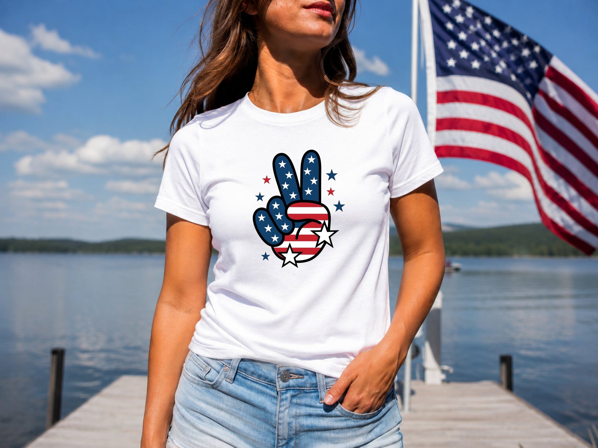 Woman wearing white t-shirt with red, white, and blue peace sign on a dock.