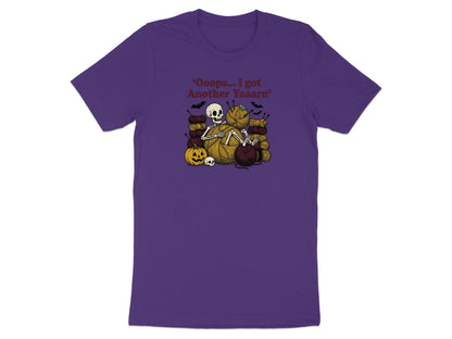 Skeleton surrounded by yarn, bats, and a pumpkin with text "Oops... I got Another Yaaarn".