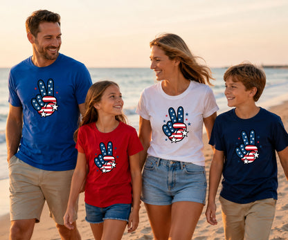 Family wearing patriotic t-shirts with peace signs on a beach.