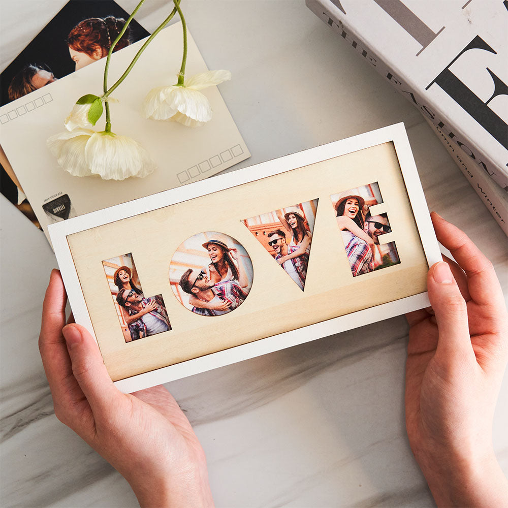 Hands holding LOVE wooden photo frame