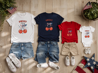Four patriotic-themed t-shirts and a baby onesie with cherry graphics.