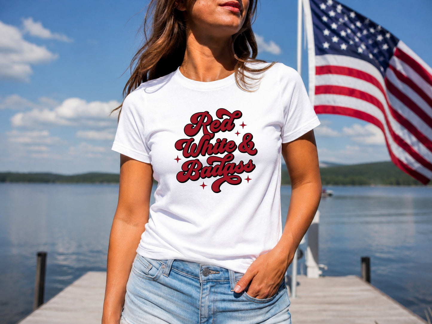 Woman wearing white t-shirt with "Red White & Badass" graphic, American flag background.