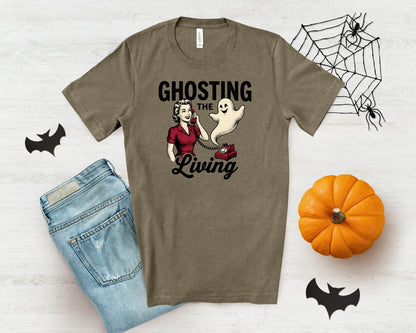 T-shirt with graphic: "Ghosting the Living" featuring a woman on a phone with a ghost and a pumpkin.
