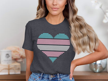 Dark grey t-shirt with a pastel pink, blue, and white striped heart graphic.