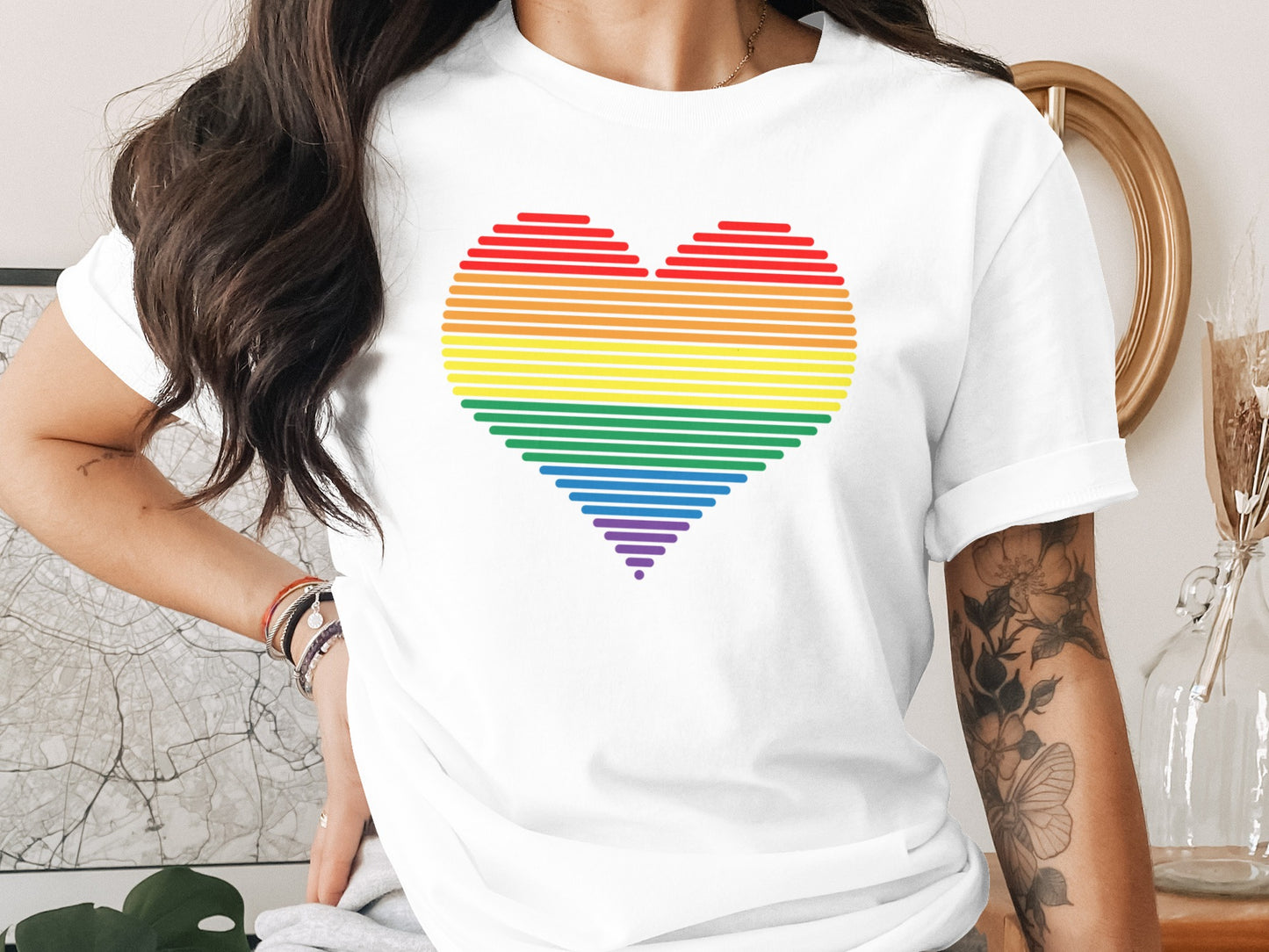 White t-shirt with rainbow heart graphic.