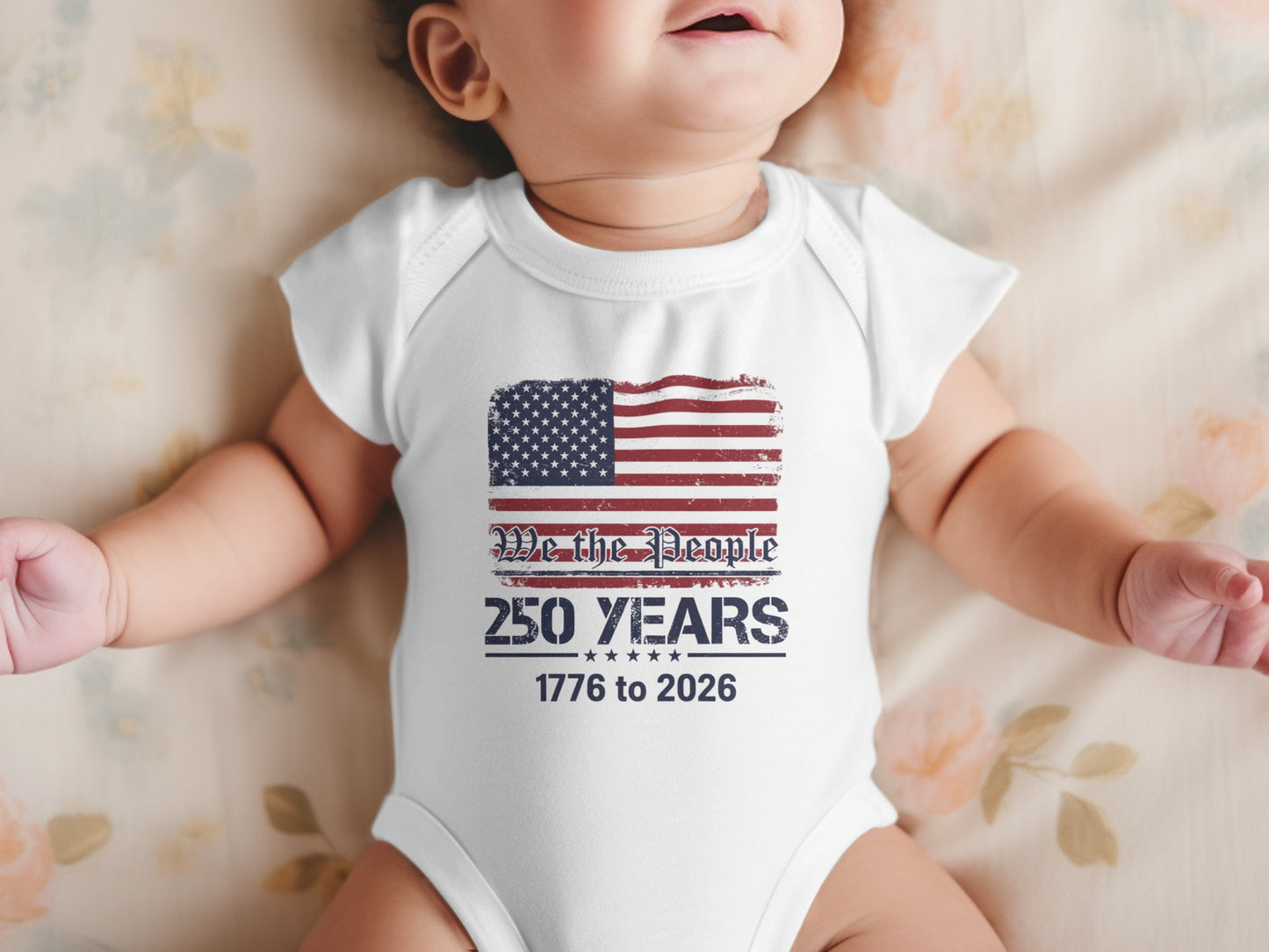 Baby in white onesie with American flag and "We the People 250 Years 1776 to 2026" text.