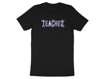 Black t-shirt with "TEACHER" in purple lettering with Halloween-themed embellishments.