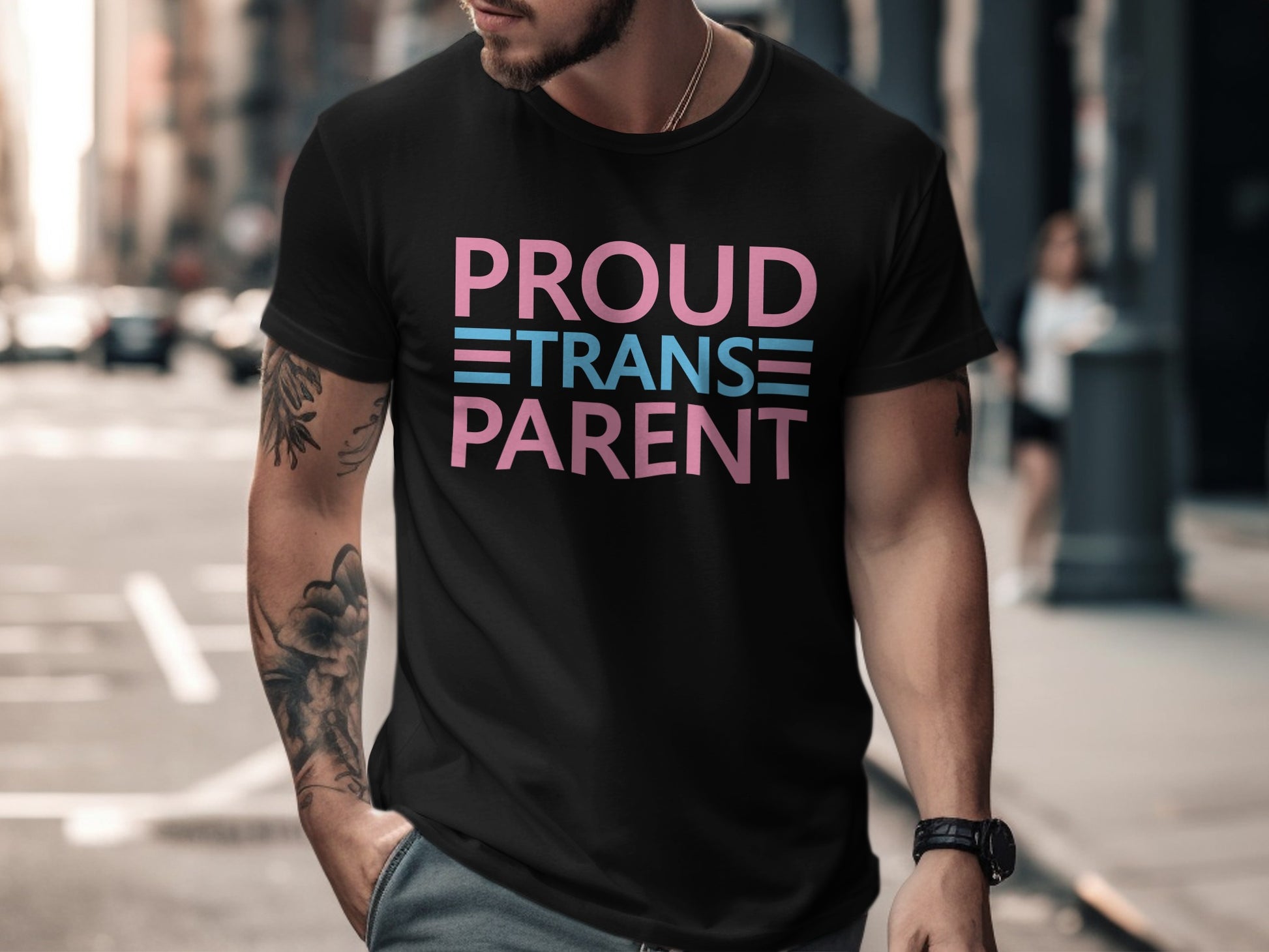 Black t-shirt with "PROUD TRANSGENDER PARENT" text in pink and blue.