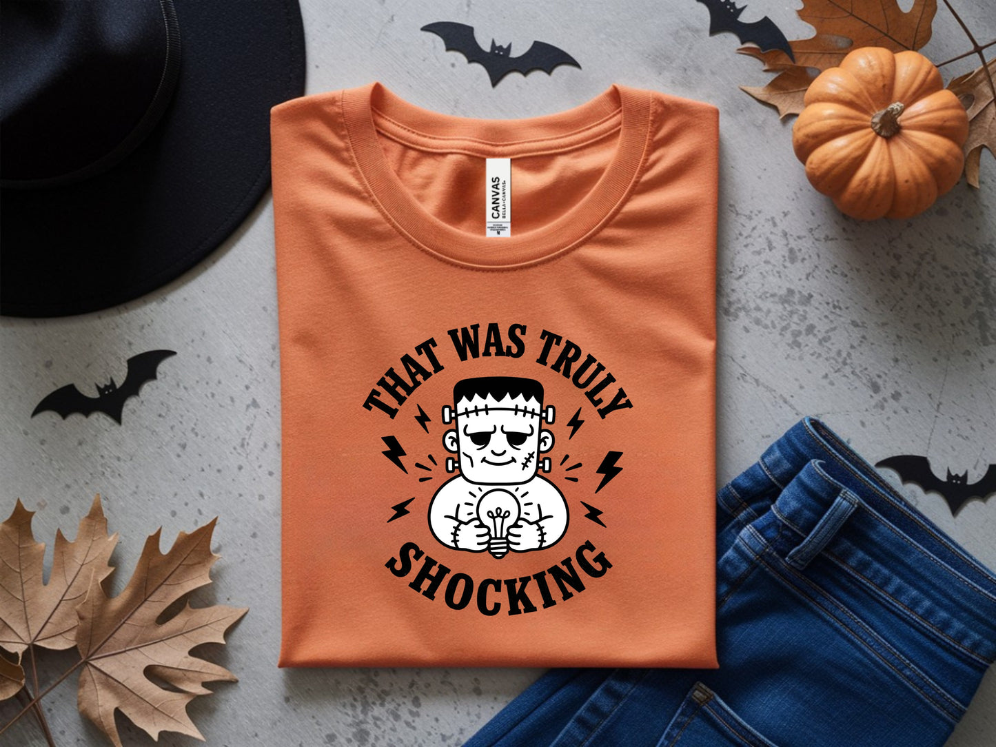 Orange t-shirt with Frankenstein graphic saying "THAT WAS TRULY SHOCKING".