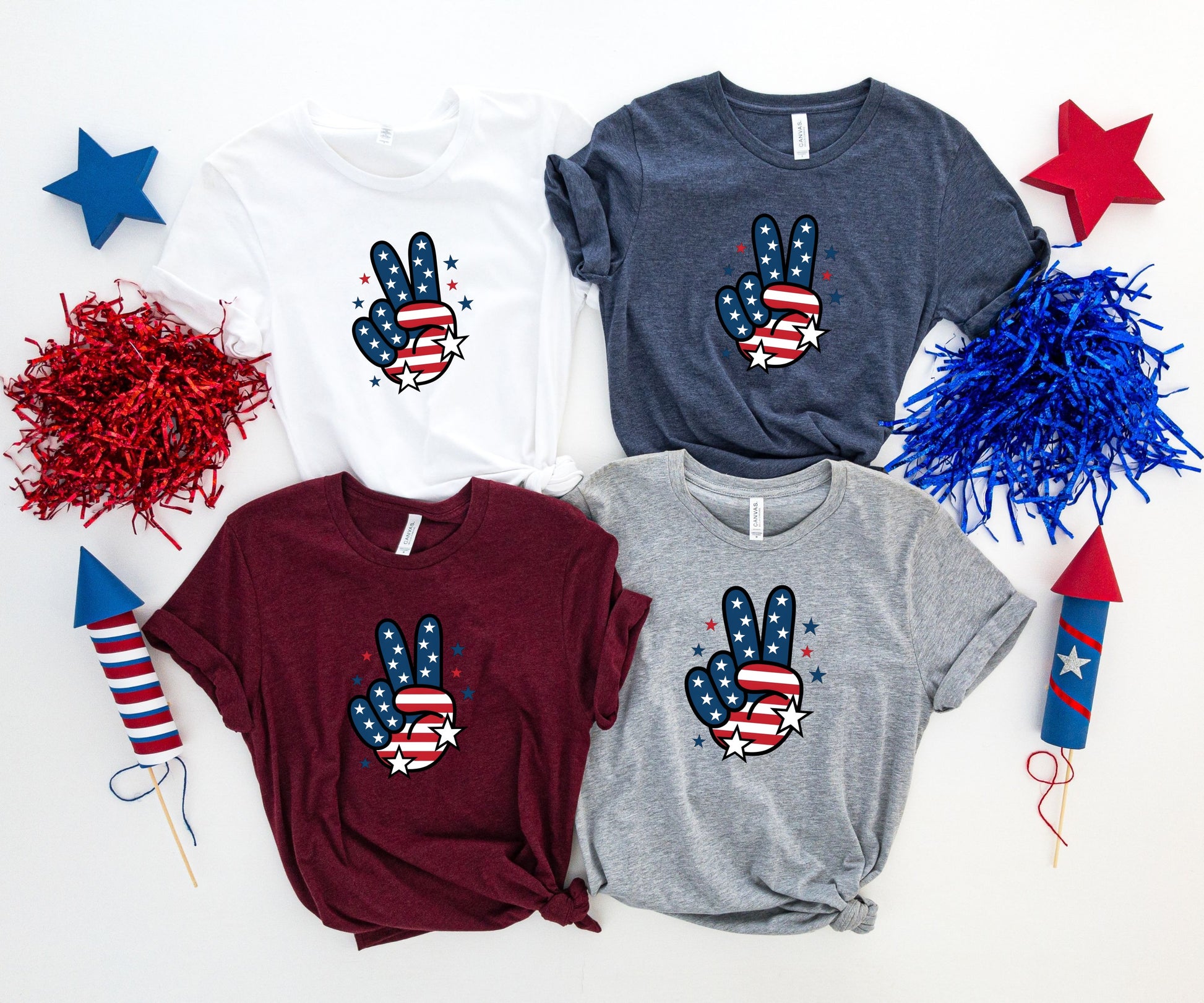 Four t-shirts with a patriotic peace sign graphic.