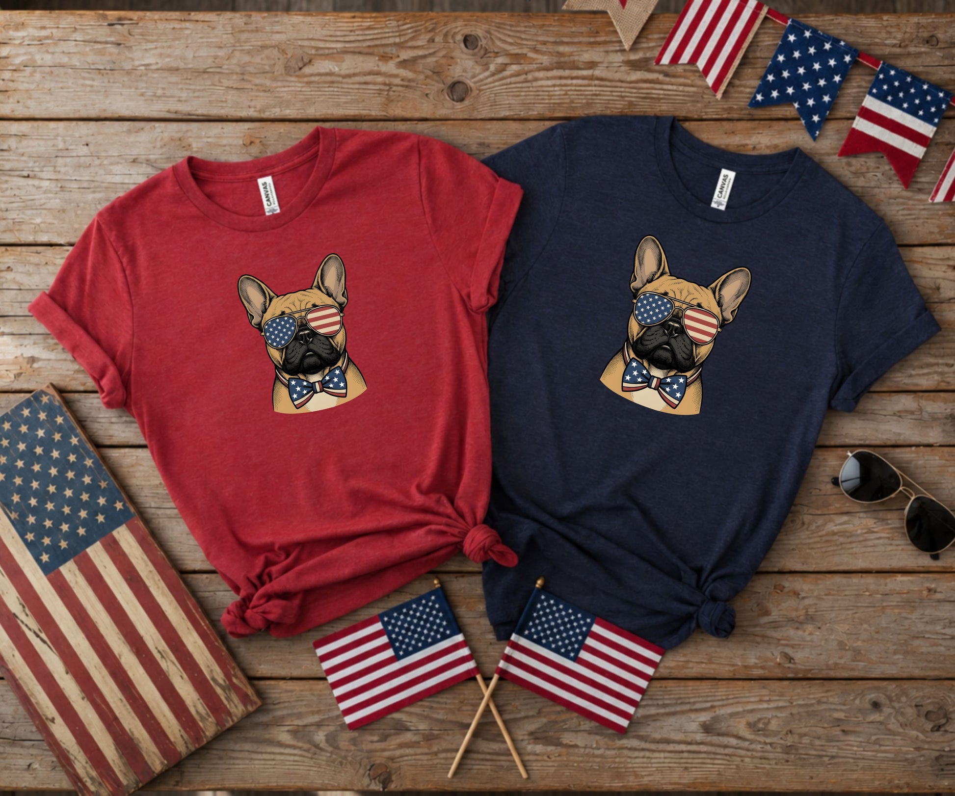 French bulldog wearing American flag sunglasses on red and navy t-shirts.