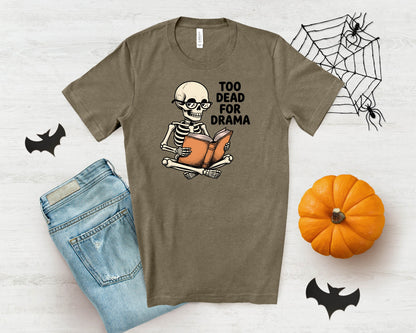 Skeleton wearing glasses reading a book with text "TOO DEAD FOR DRAMA".