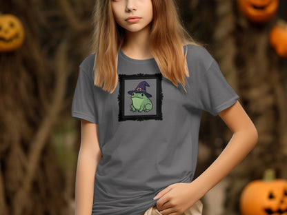 Grey t-shirt with a framed drawing of a frog wearing a witch hat.