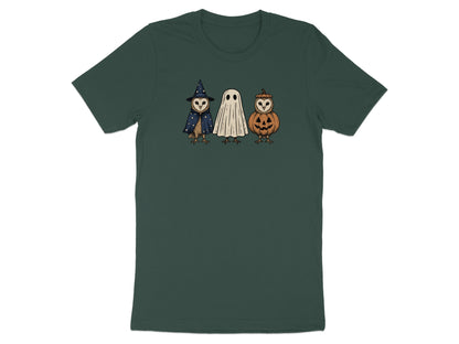 Three cartoon owls dressed as a witch, a ghost, and a jack-o'-lantern on a dark green t-shirt.