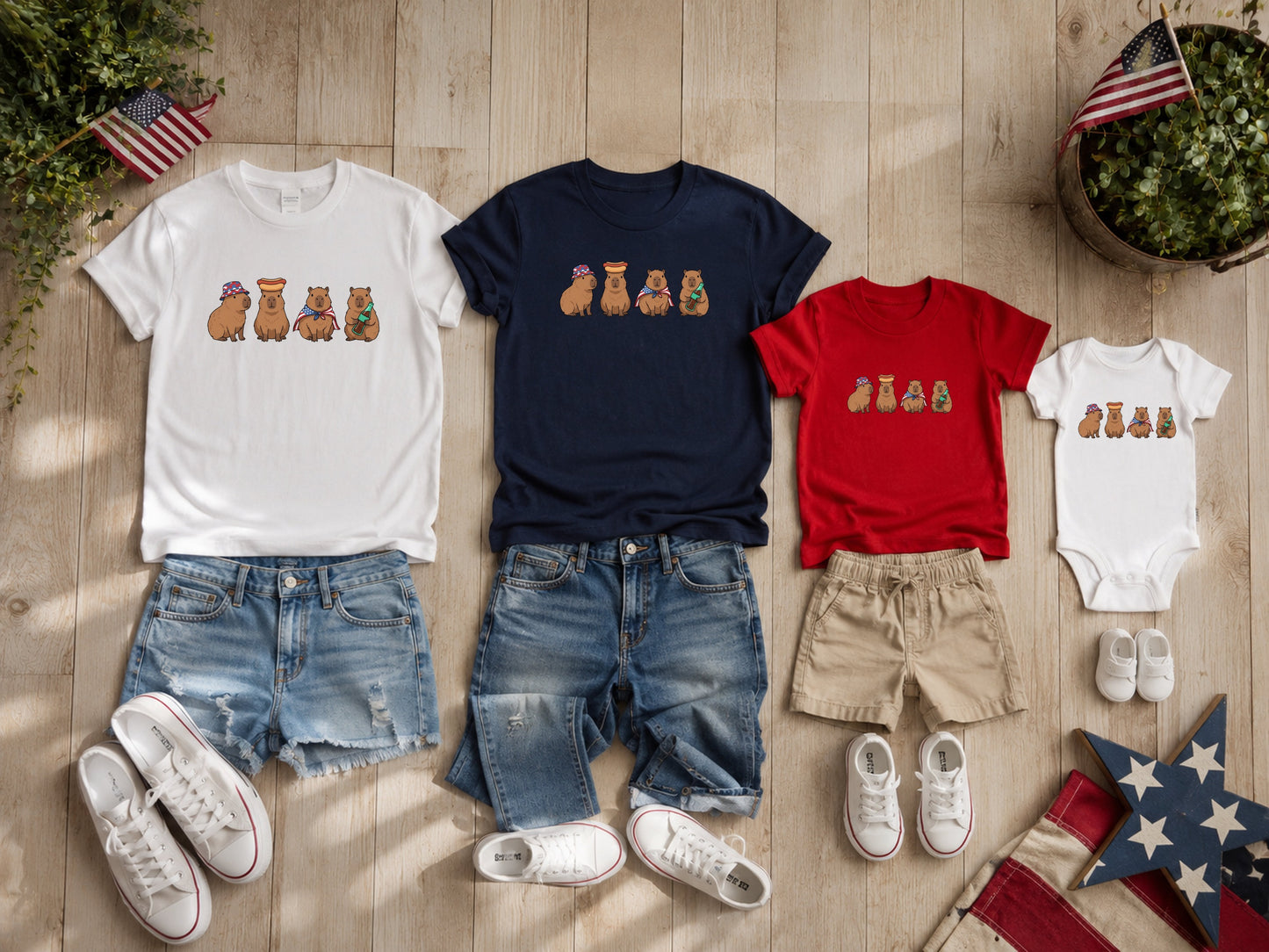 Capybaras wearing festive hats on white, navy, and red t-shirts and onesie.