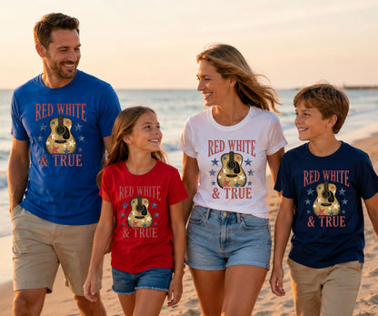 Family of four on beach wearing matching "Red White & True" patriotic t-shirts.