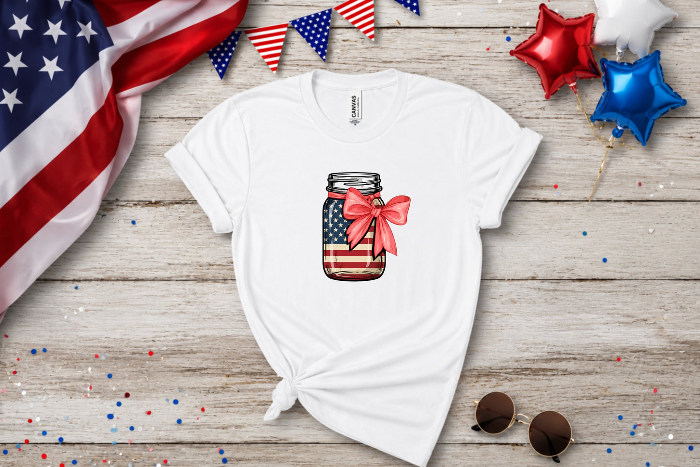 White t-shirt with American flag mason jar graphic and red bow.