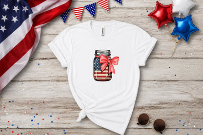 White t-shirt with American flag mason jar graphic and red bow.