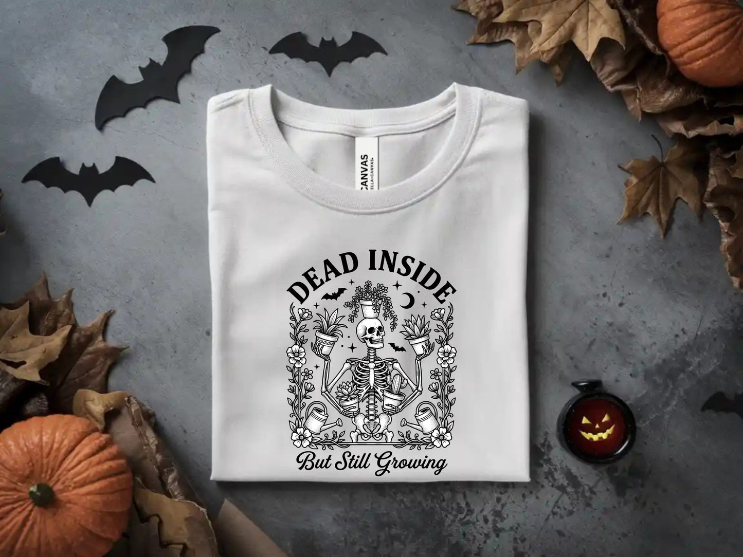 White t-shirt with skeleton, plants, and text "Dead Inside But Still Growing".