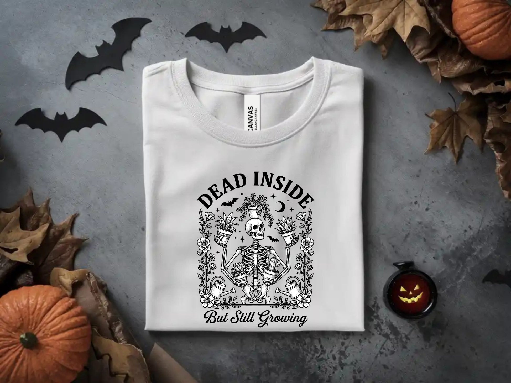 White t-shirt with skeleton, plants, and text "Dead Inside But Still Growing".