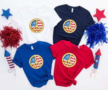 Four t-shirts with peace signs featuring the American flag design.