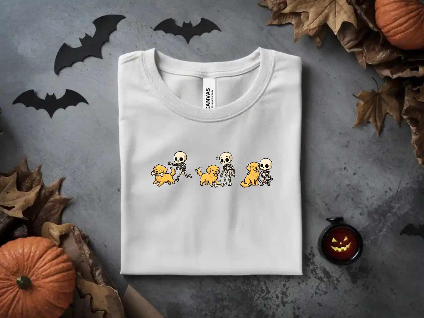 White t-shirt with cartoon skeletons playing with golden retrievers graphic.
