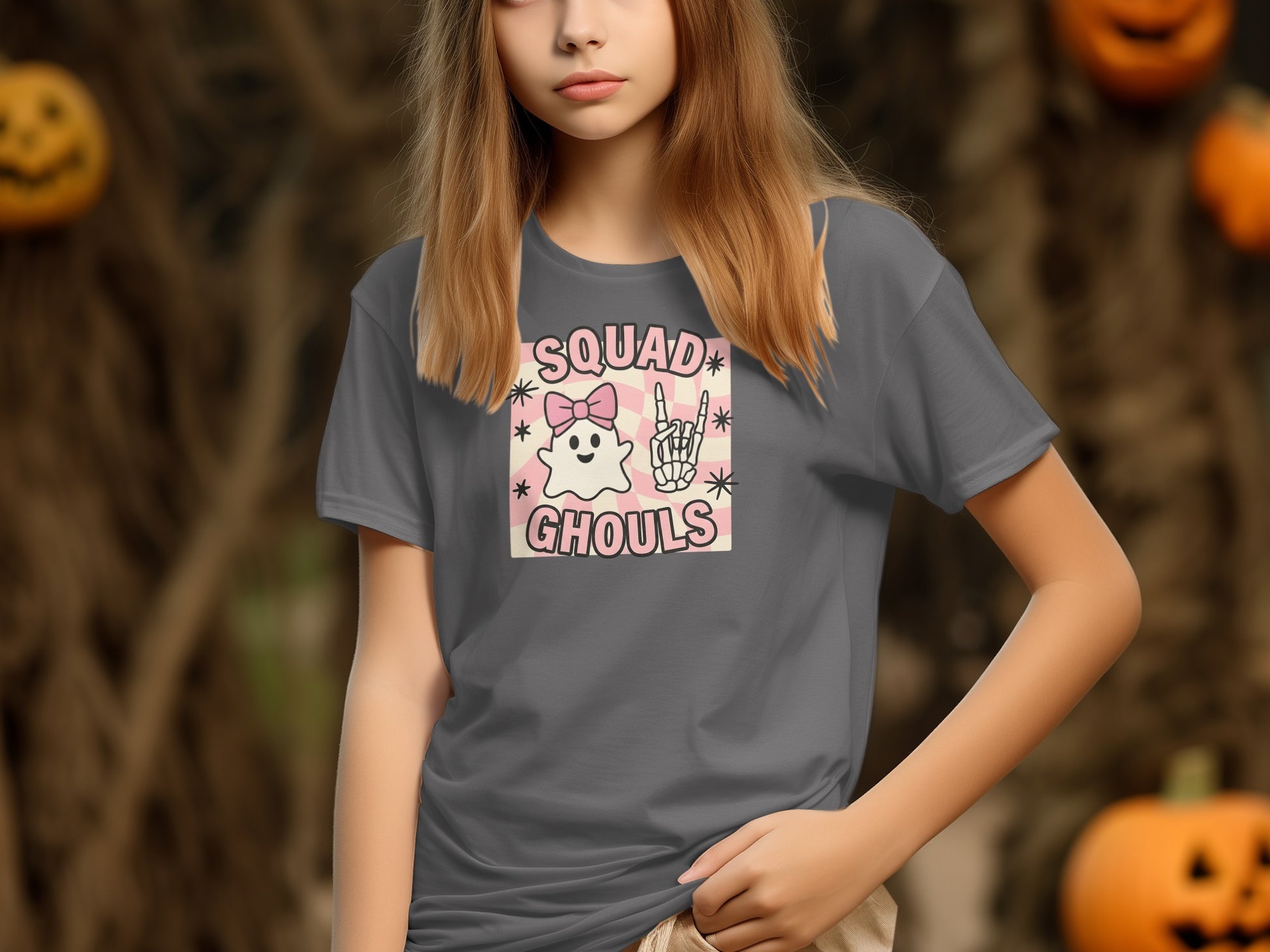 Girl in grey t-shirt with "Squad Ghouls" and ghost graphic at Halloween party.