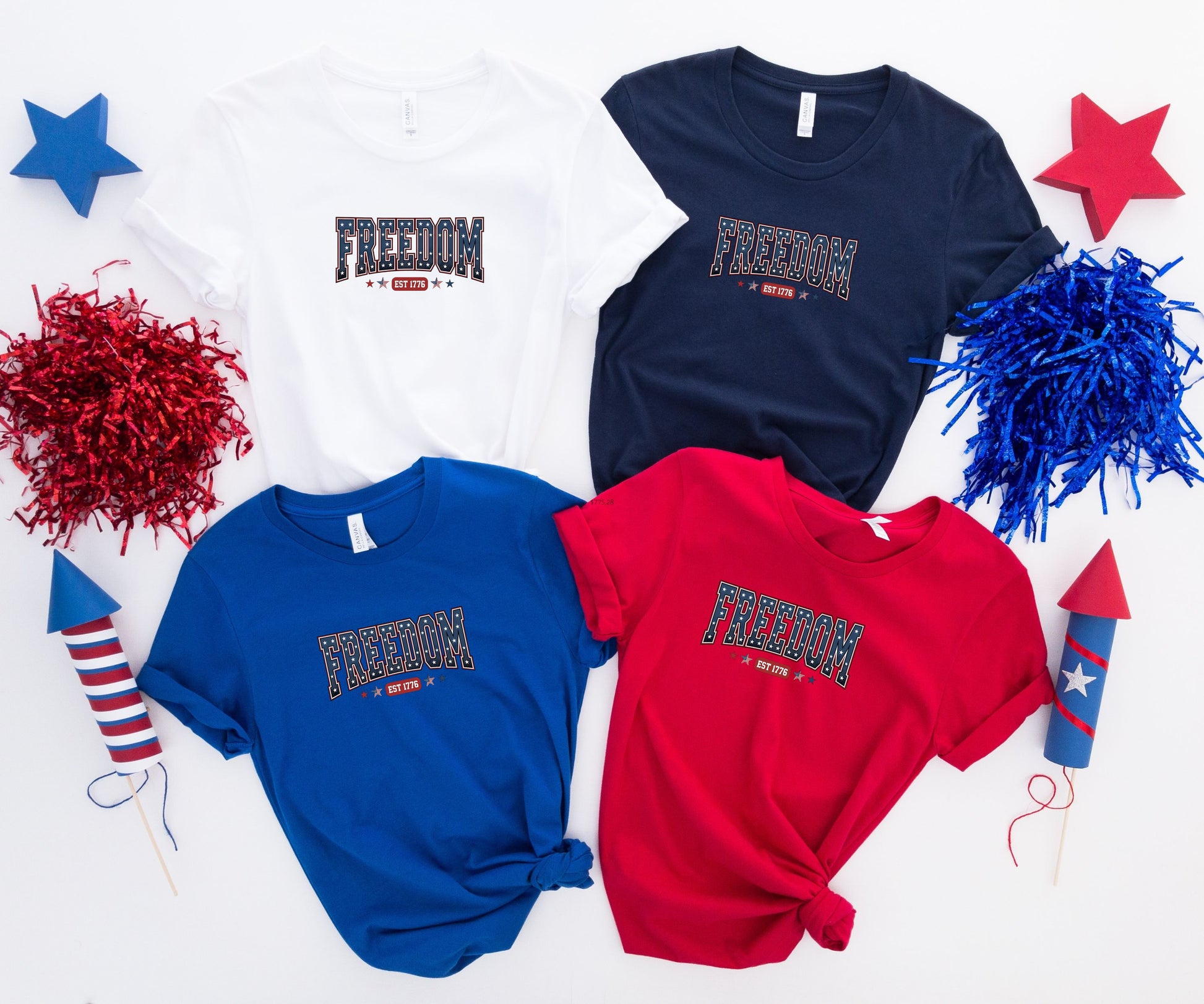 Four t-shirts with "FREEDOM EST 1776" graphic in white, navy, royal blue, and red.