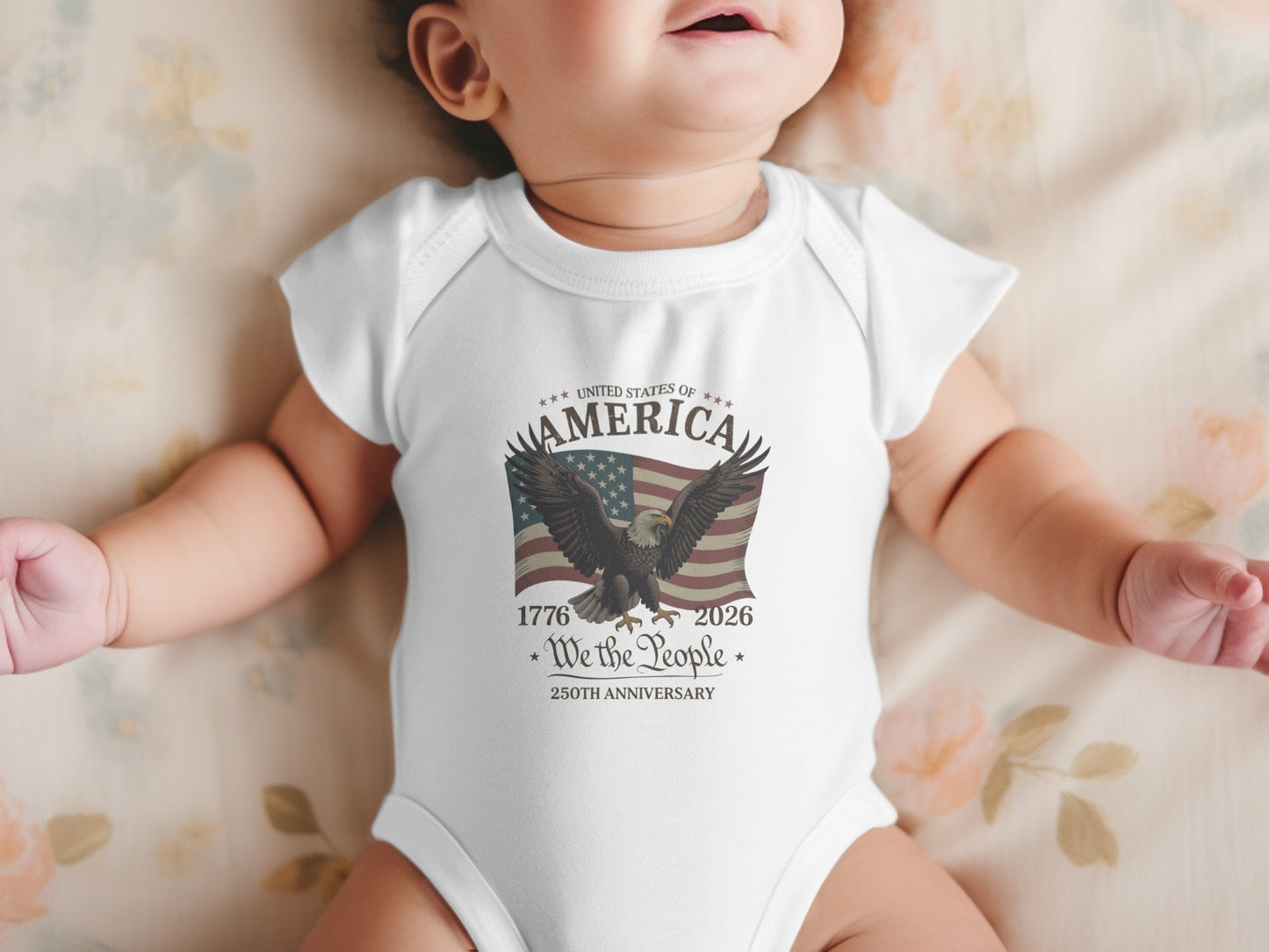 White baby onesie with American flag, eagle, and "250th Anniversary" text.