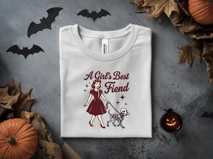 White t-shirt with "A Girl's Best Fiend" text and skeleton dog graphic.