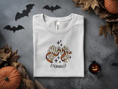 White t-shirt with skeleton hands entwined in ribbon, "ETERNALLY" text.