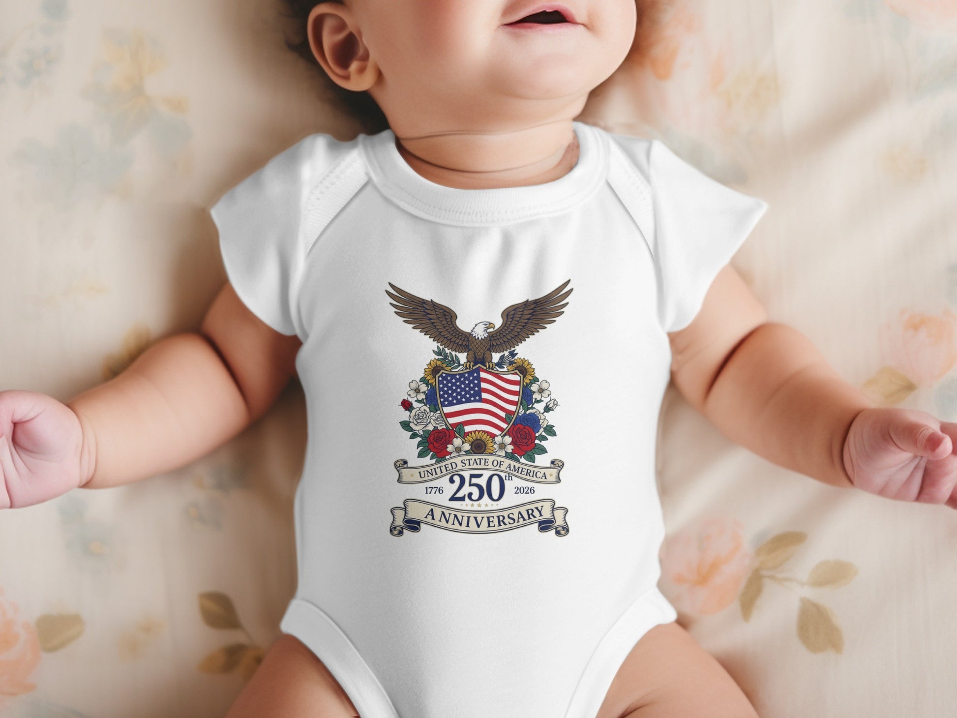 Baby wearing a white onesie with the United States 250th Anniversary logo.