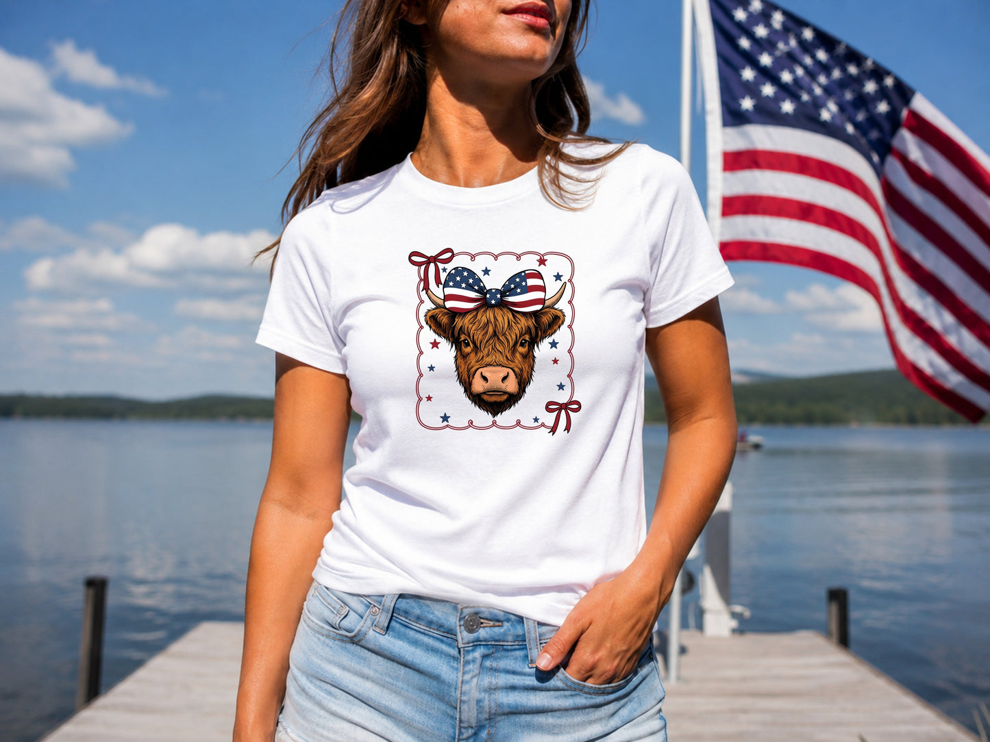 White t-shirt with a graphic of a cow wearing a red, white, and blue bow and American flag.