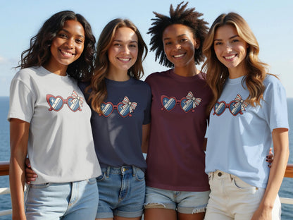 Four smiling women wear patriotic themed t-shirts and sunglasses.