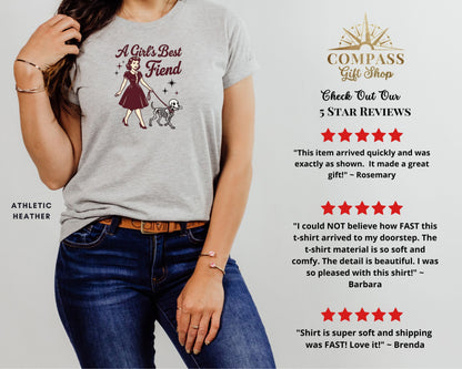 Grey t-shirt with graphic of a woman walking a skeleton dog, text "A Girl's Best Fiend."