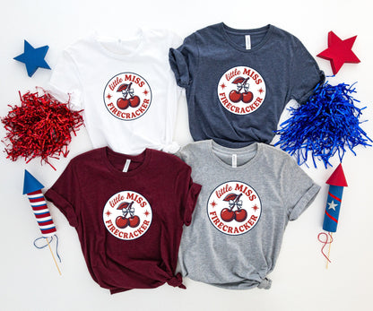 Four t-shirts with "little MISS FIRECRACKER" design and cherry graphic.