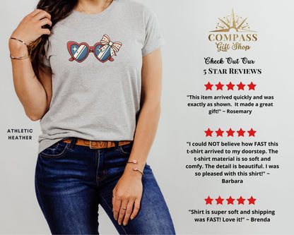 Gray t-shirt with red, white, and blue star-spangled sunglasses and bow graphic.