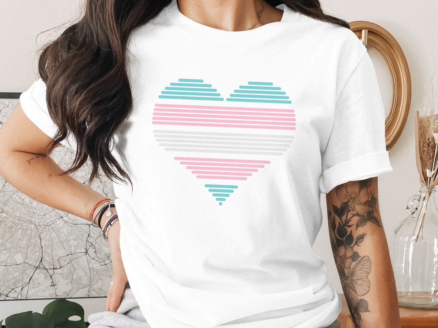 White t-shirt with a pastel transgender pride flag heart design.