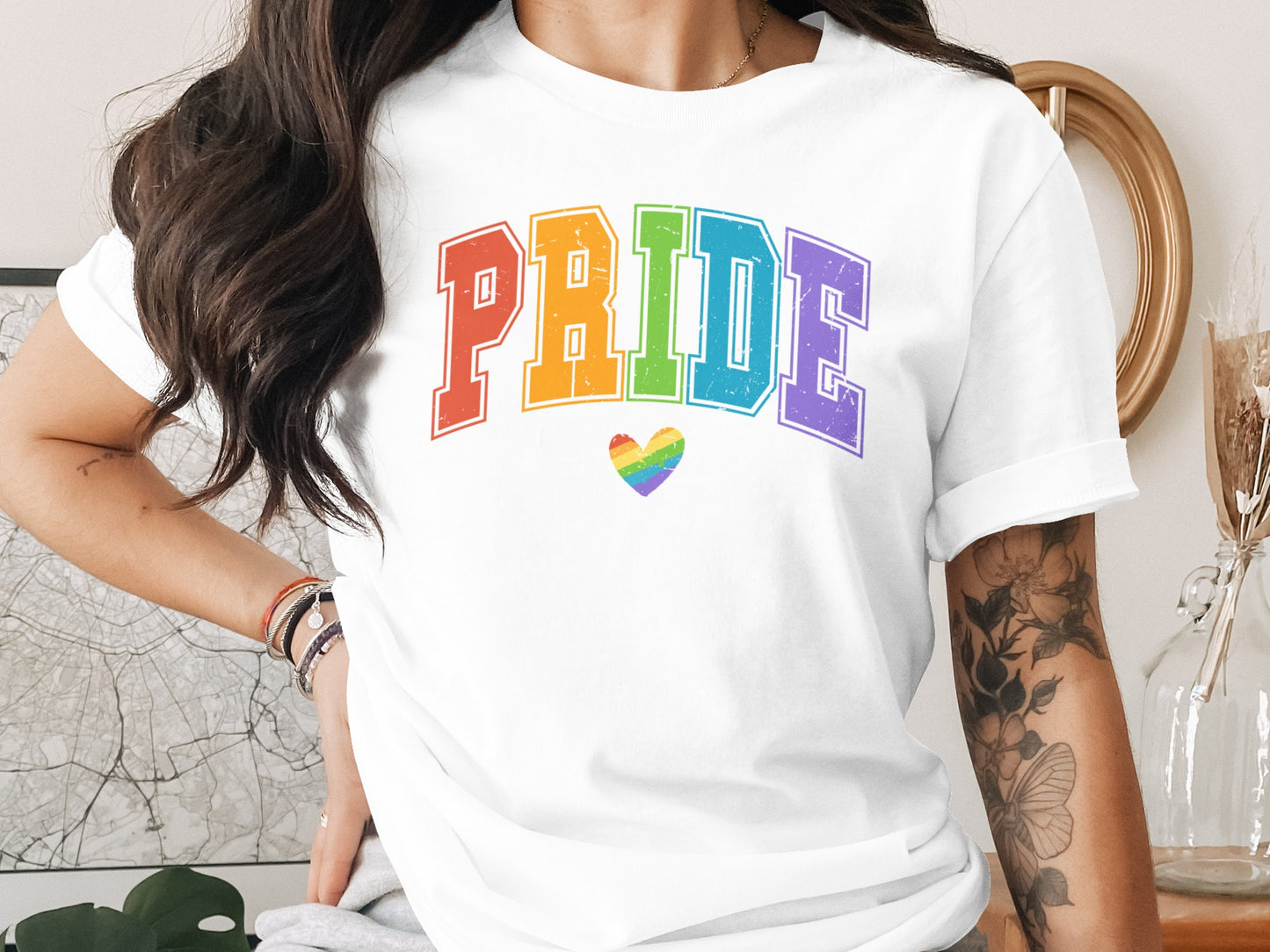 White t-shirt with "PRIDE" text in colorful block letters and a rainbow heart.