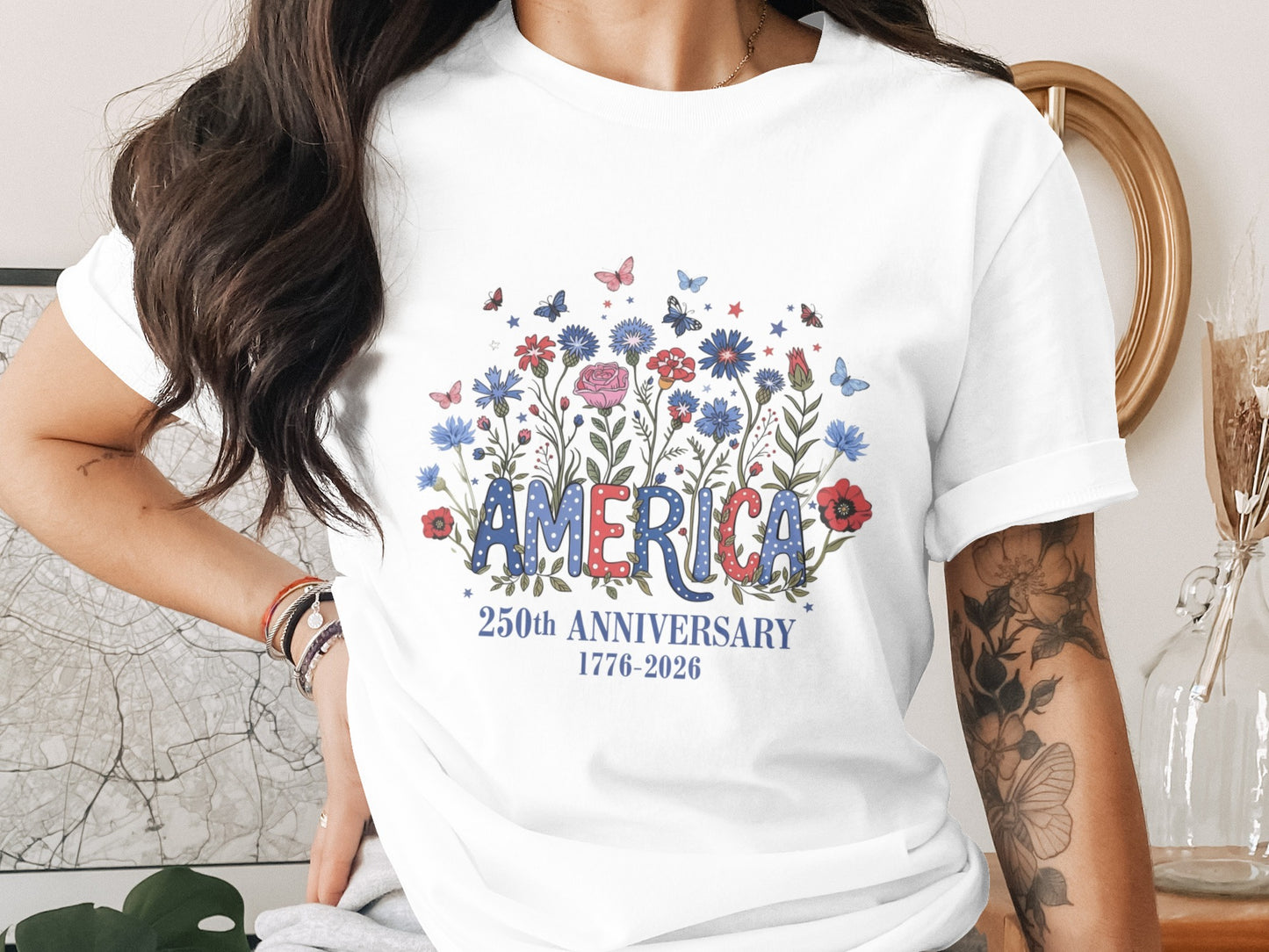 T-shirt with "America" in floral lettering, celebrating 250th anniversary.