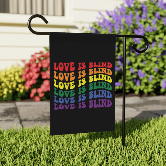Black garden flag with rainbow text reading "LOVE IS BLIND" repeated six times.
