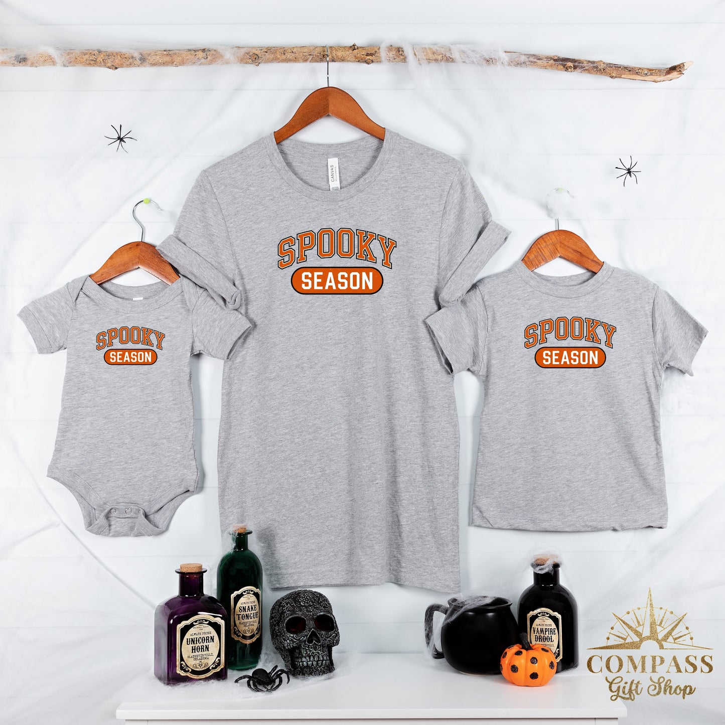 Three grey t-shirts, one baby bodysuit and two adult t-shirts, with "Spooky Season" text.