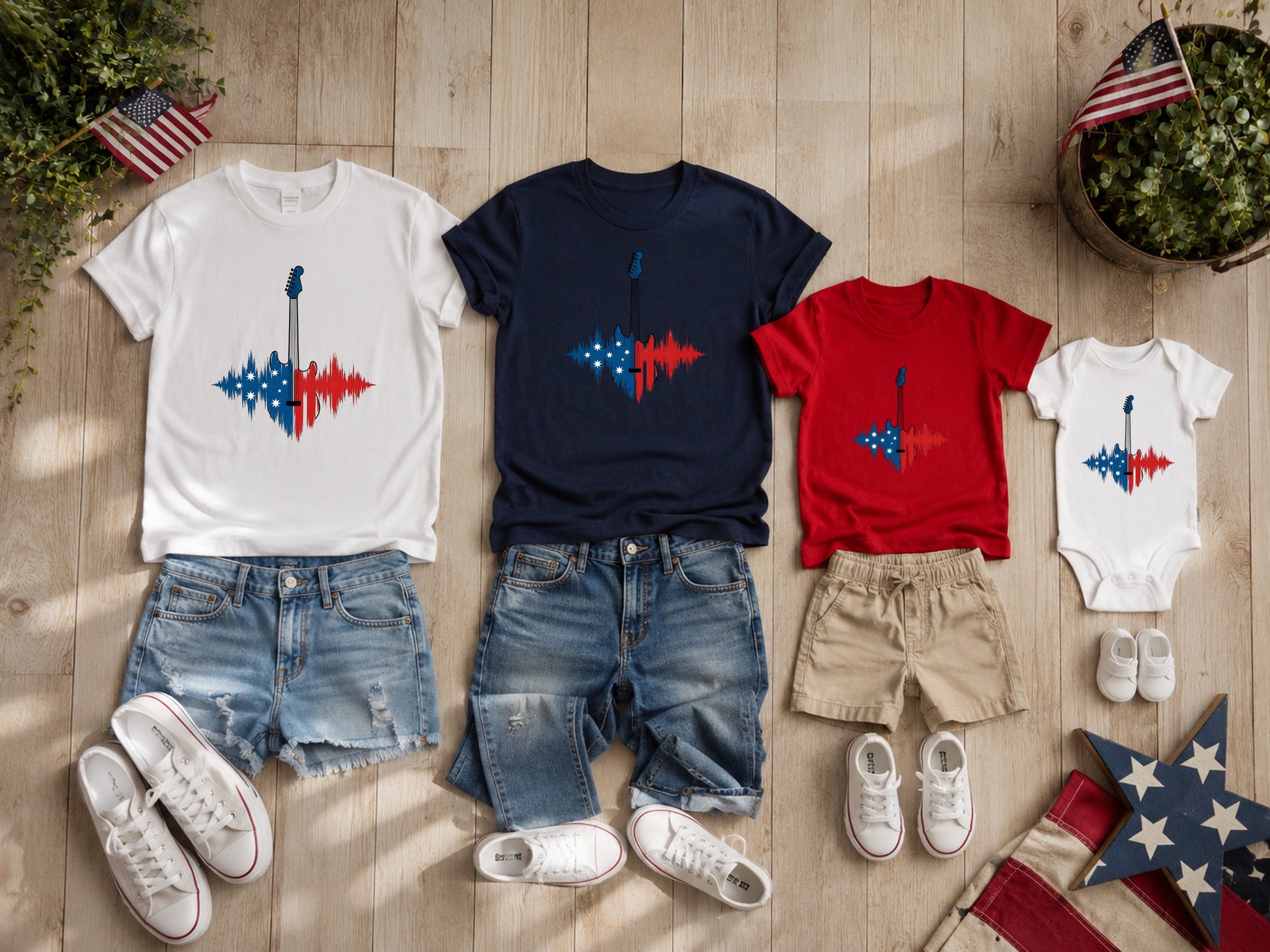 Matching patriotic t-shirts and onesie with guitars on a wooden background.