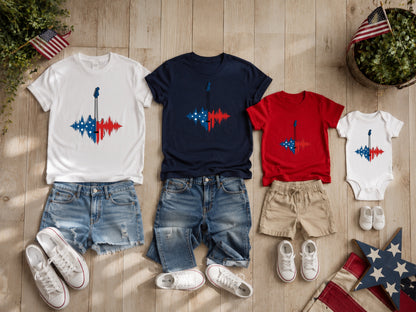 Matching patriotic t-shirts and onesie with guitars on a wooden background.