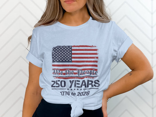 White t-shirt with distressed American flag and text "We the People 250 Years 1776 to 2026".