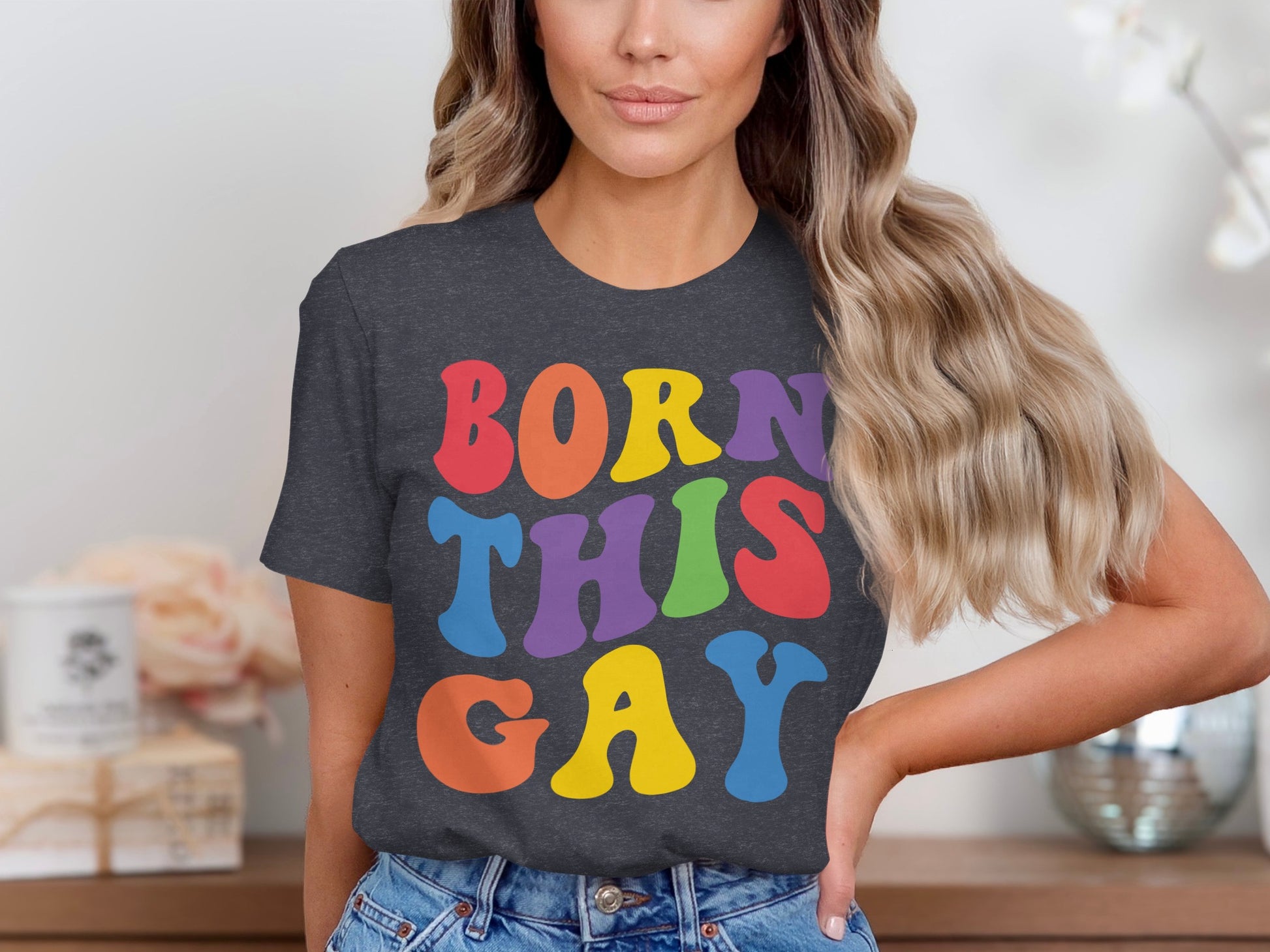 Woman wearing a dark grey t-shirt with "BORN THIS GAY" in colorful block letters.