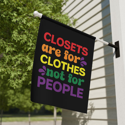 Black flag with rainbow text reading "Closets are for clothes, not for people."